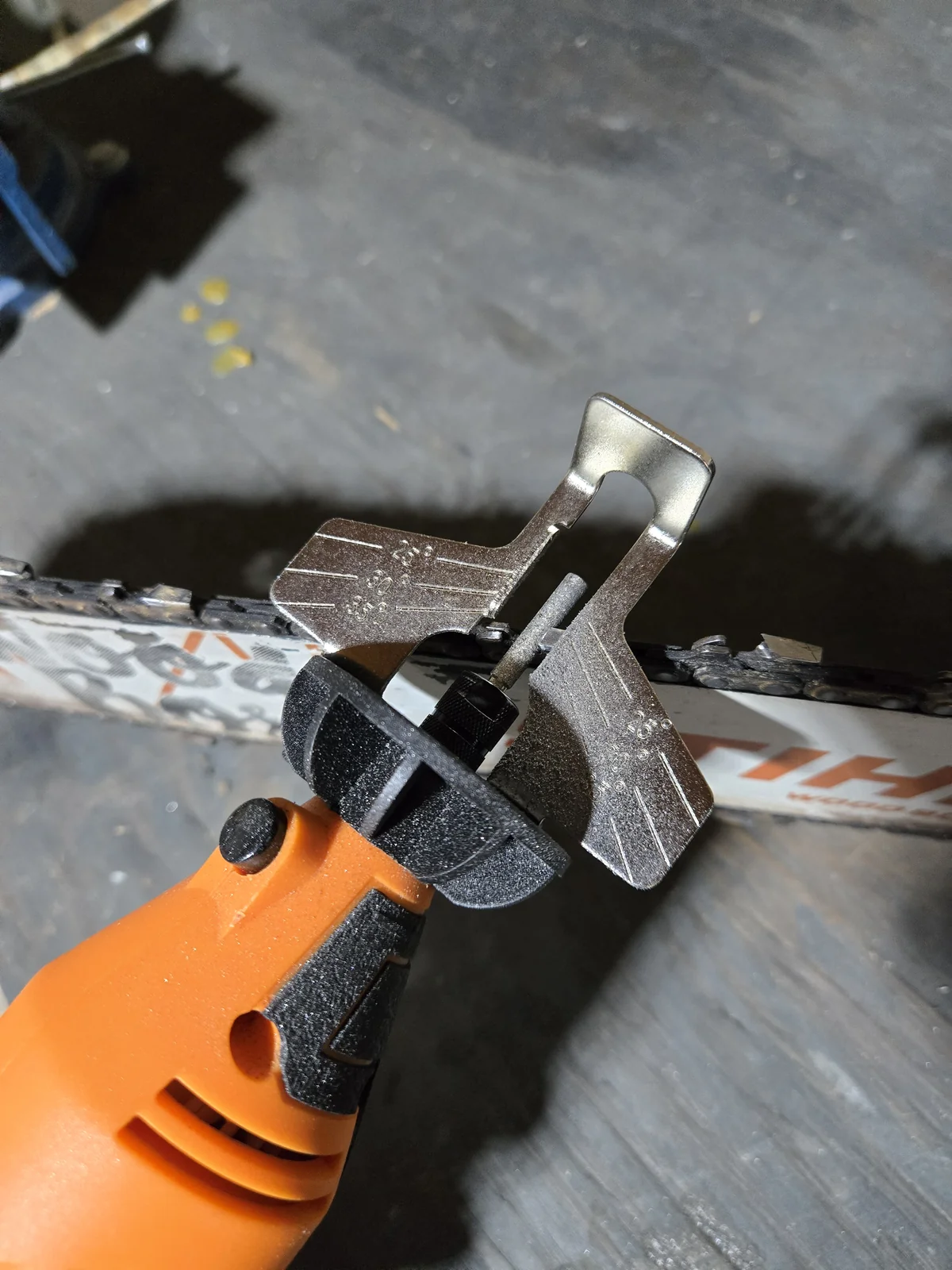 The rotary sharpener with the angle guide and 3/16 inch stone resting on a cutter