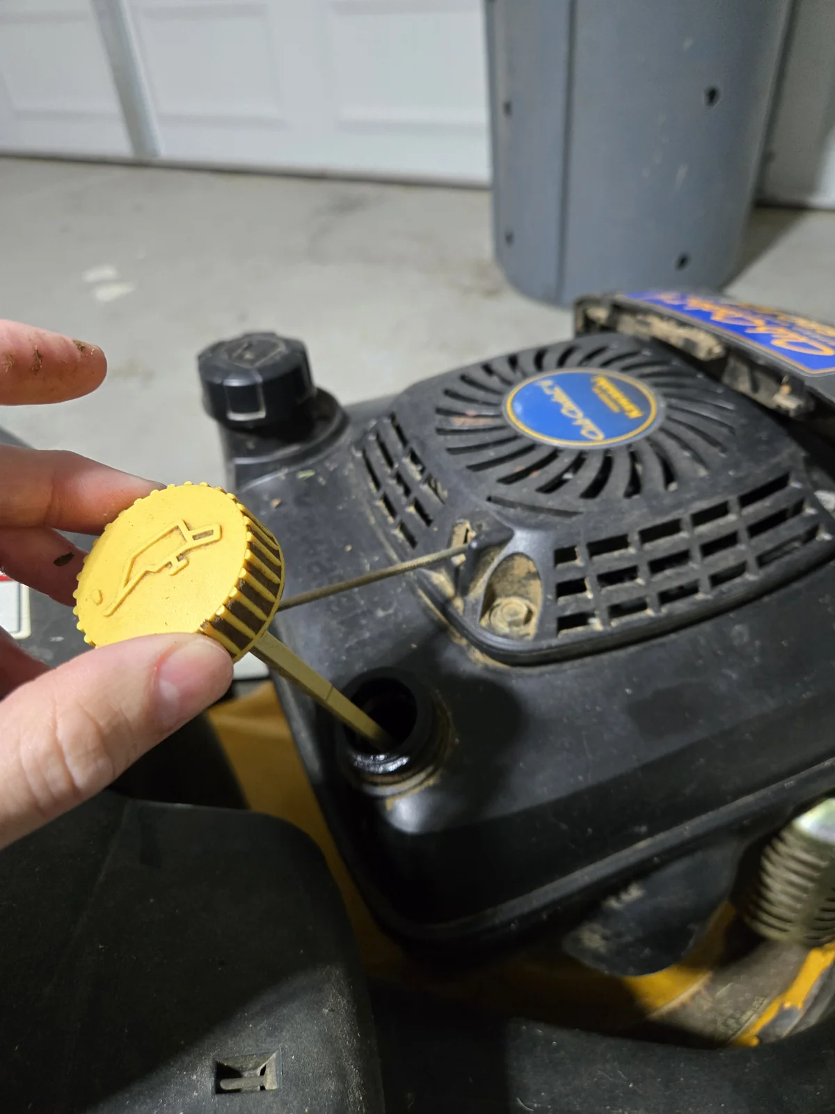 Cub Cadet oil dipstick — pull this and tip the mower to drain