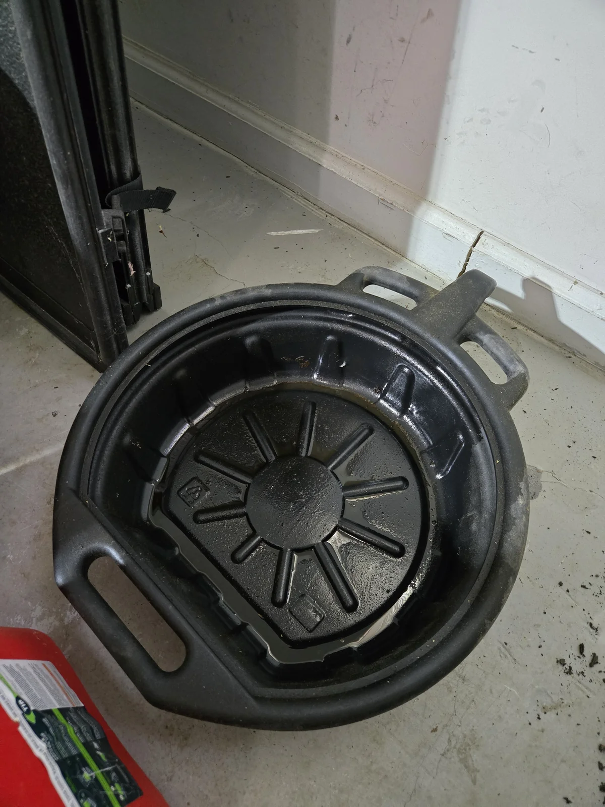 Open-style oil drain pan I've been using — it works but you have to dispose of the oil after each change