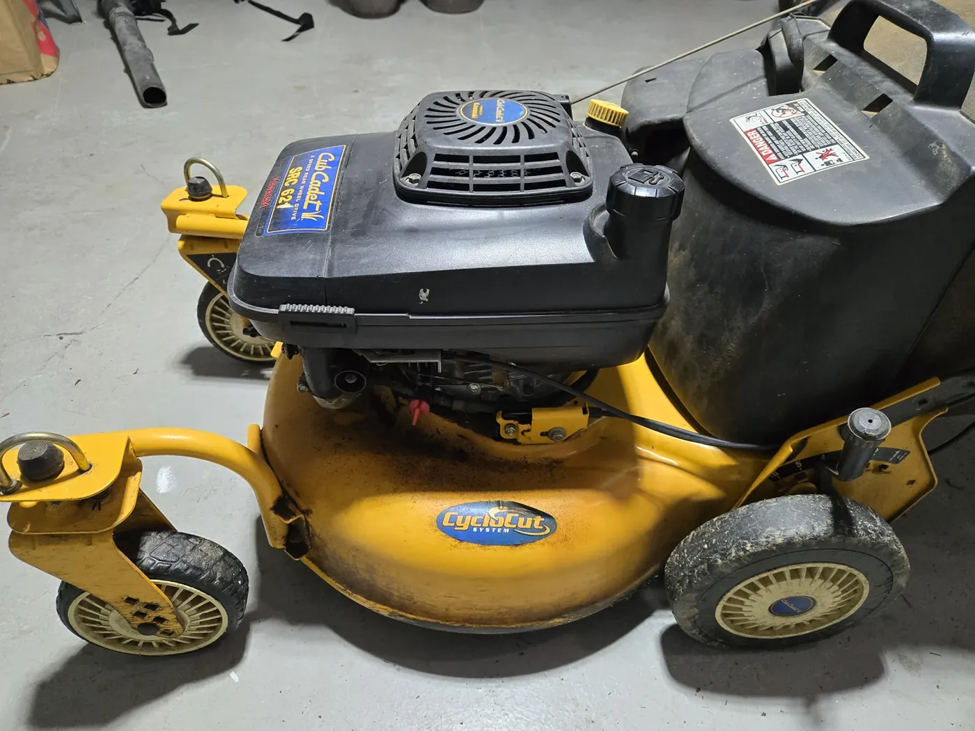 The Cub Cadet's Kawasaki engine and fuel tank — the last mow of the season runs this tank dry