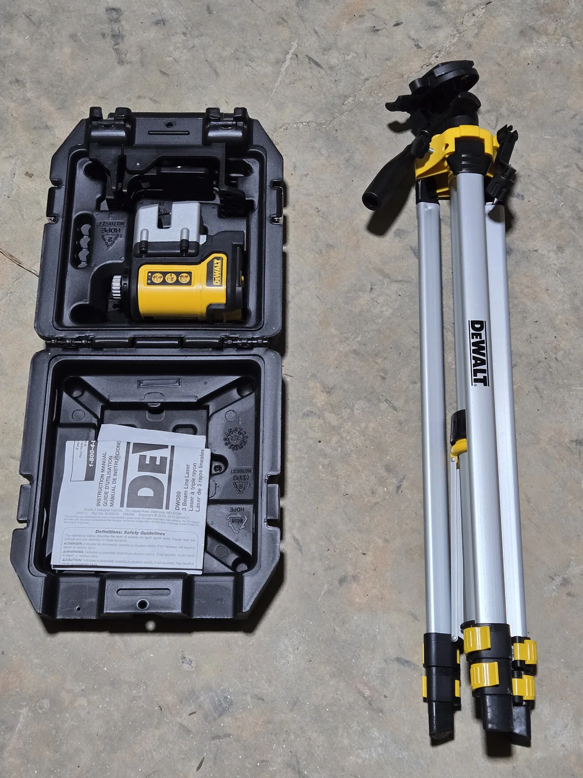 DEWALT 3-way laser level on tripod, green horizontal line projected across the wall