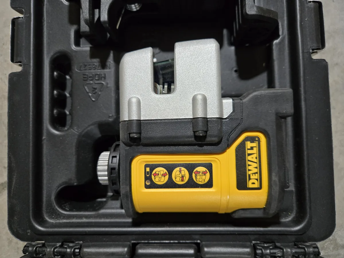 DeWalt DW0822CG close-up showing the three mode buttons — horizontal, cross-line, and vertical