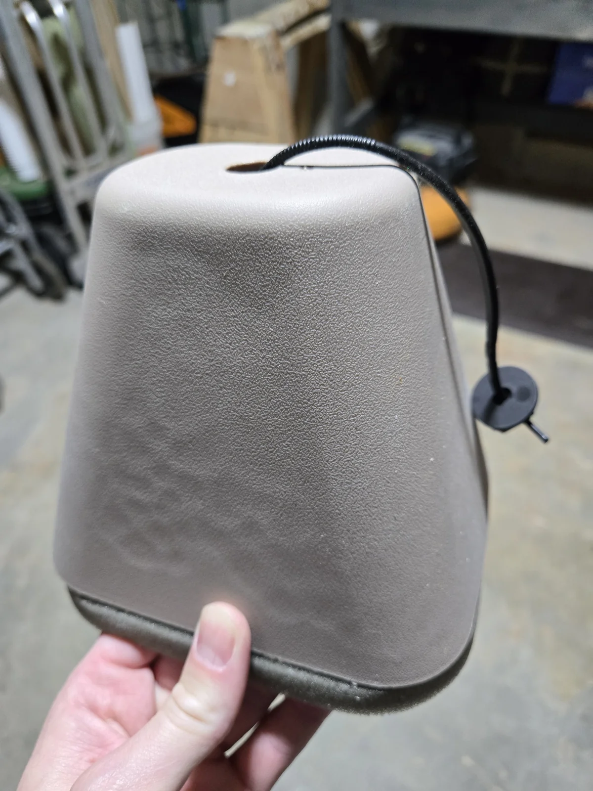 Foam faucet cover — a rigid shell, a gasket edge, and a cinch loop