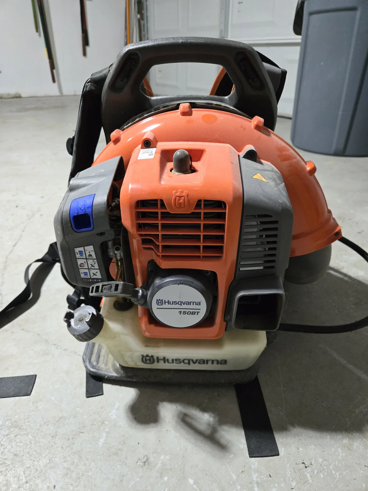 The backpack blower that moves the yard into rows — mine's the Husqvarna 150BT; the current version is the 350BT