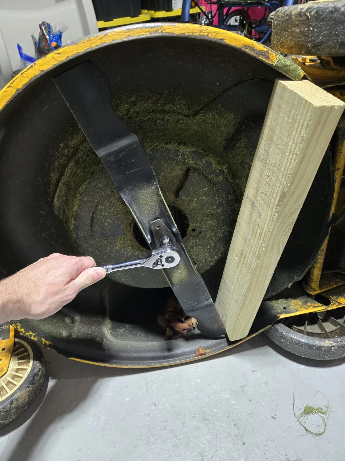 Ratchet on the blade bolt with the 2x4 blocking the blade from spinning