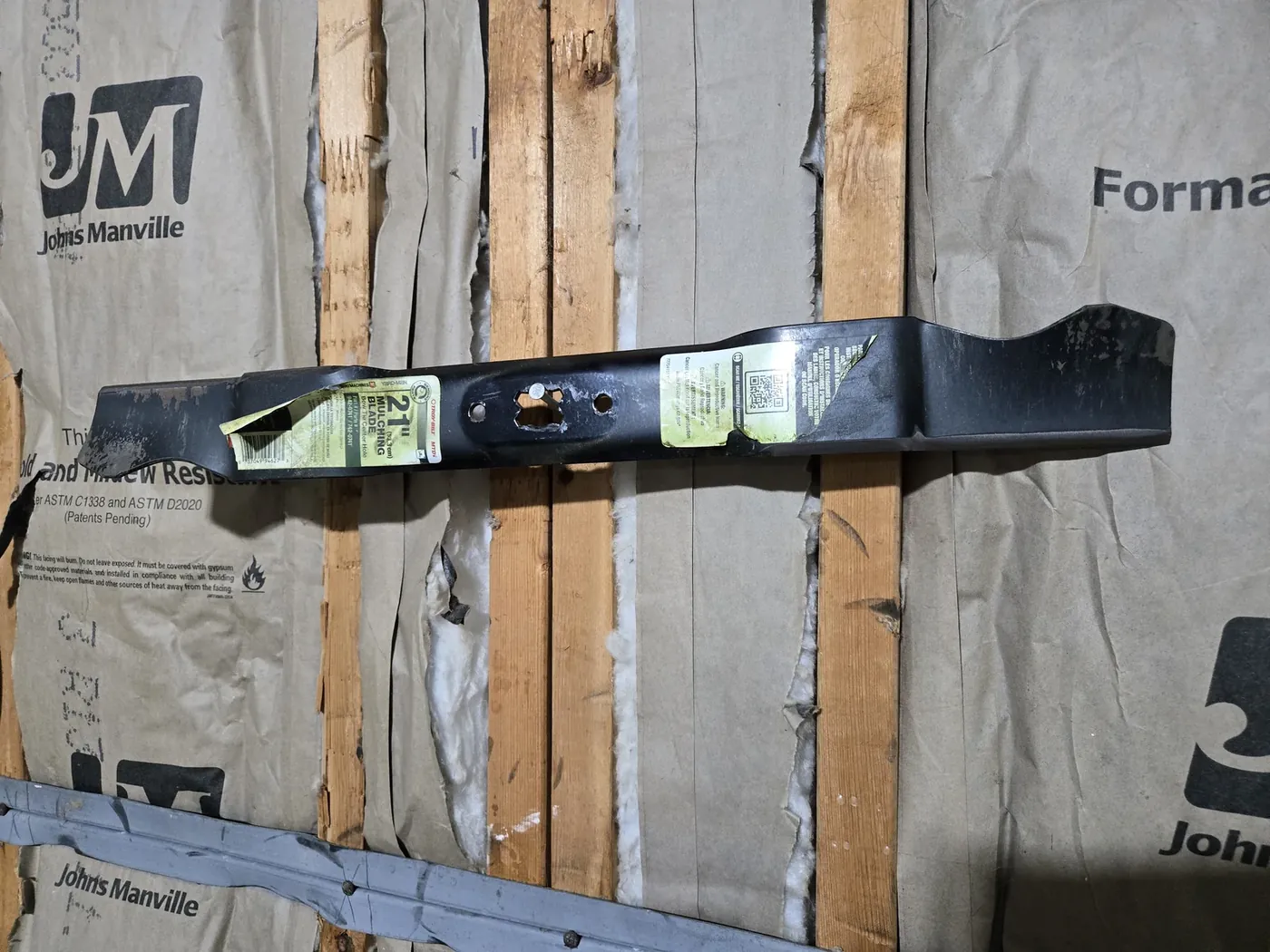 Sharpened blade hanging level on a nail in a wall stud — the balance test