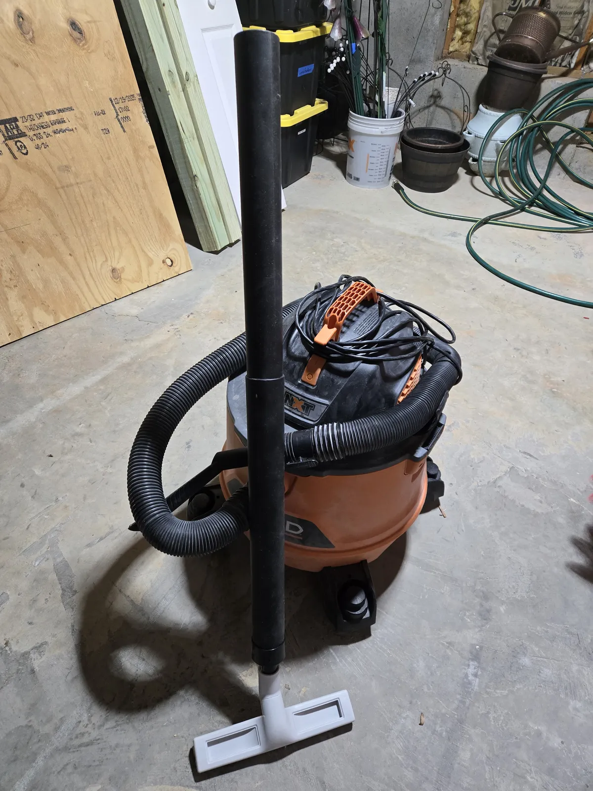 My RIDGID with the custom vacuum attachment — extension wands and soft brush head connected via the hose reducer