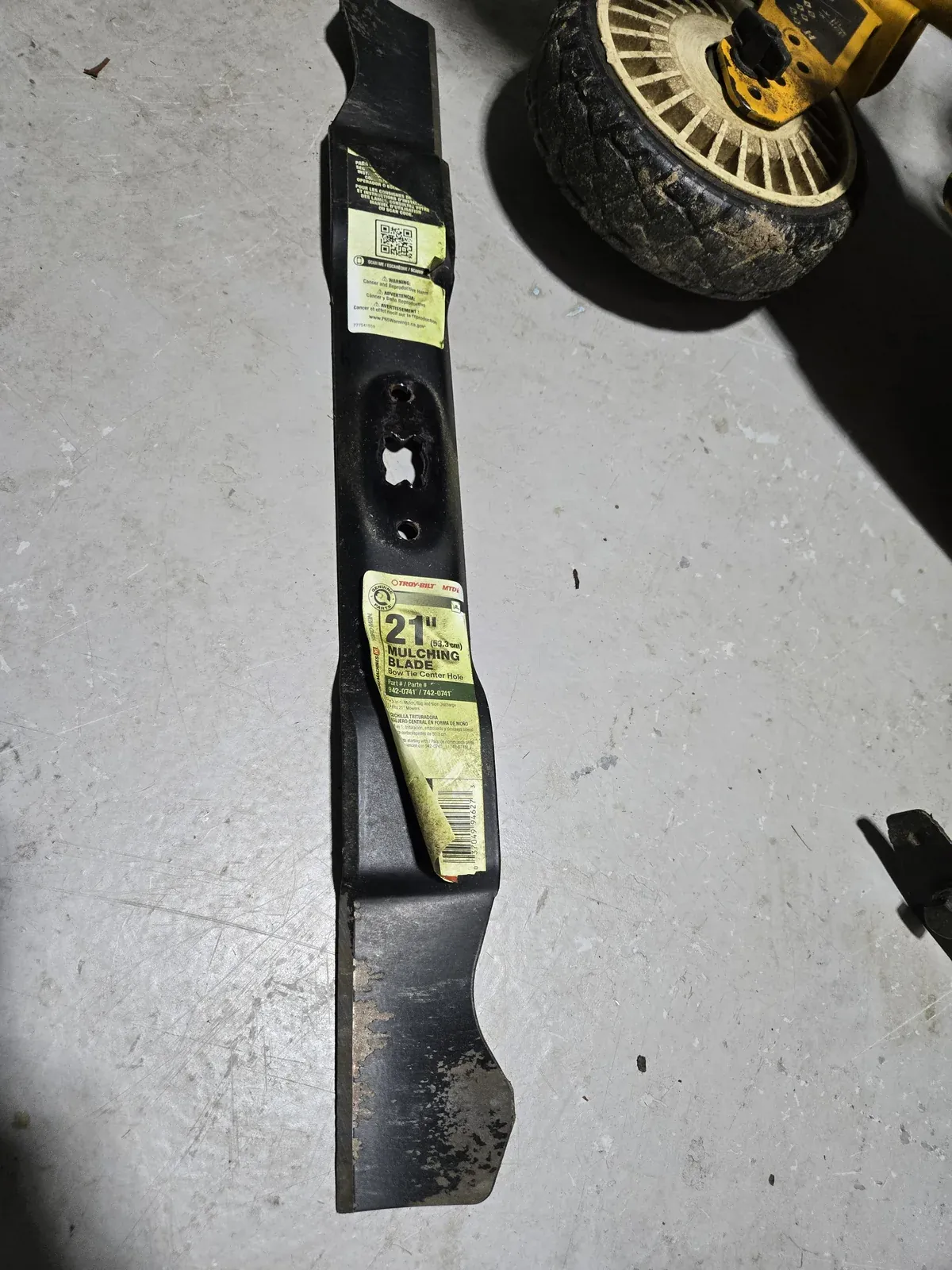 The Troy-Bilt 21-inch mulching blade off the mower, one season old
