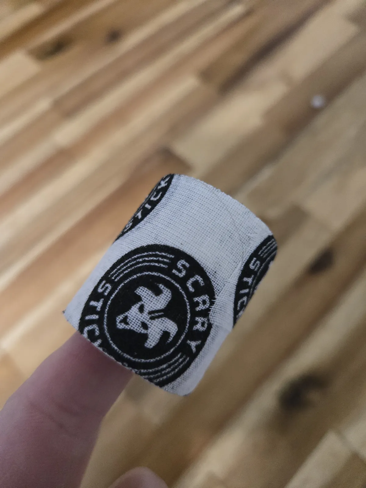 Goat Tape wrapped around my thumb below the knuckle — this is the spot that tears during bar muscle-ups if you don't protect it
