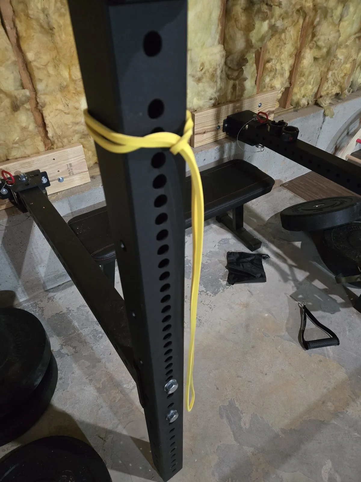 Yellow resistance band attached to my pull-up rig — this is where most of my shoulder and lat stretching happens