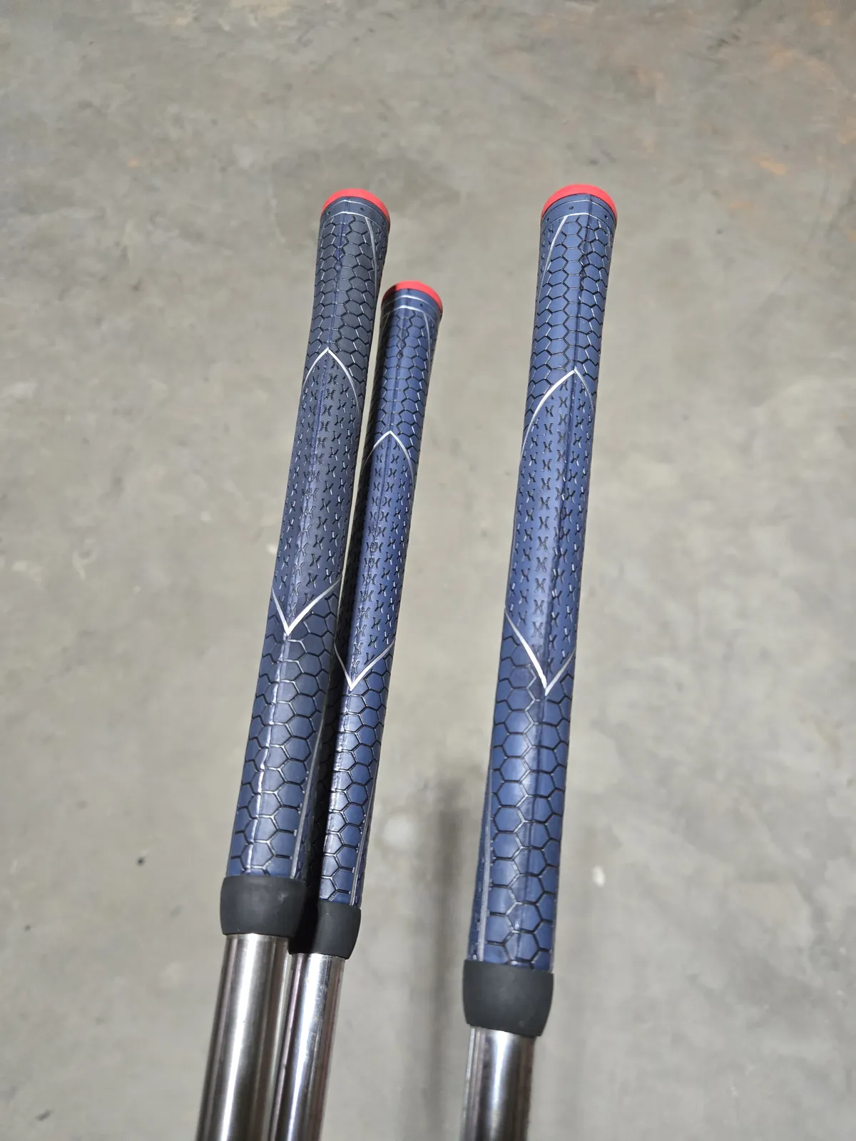 Fresh Winn Dri-Tac grips on two of my clubs — the blue honeycomb texture is distinctive