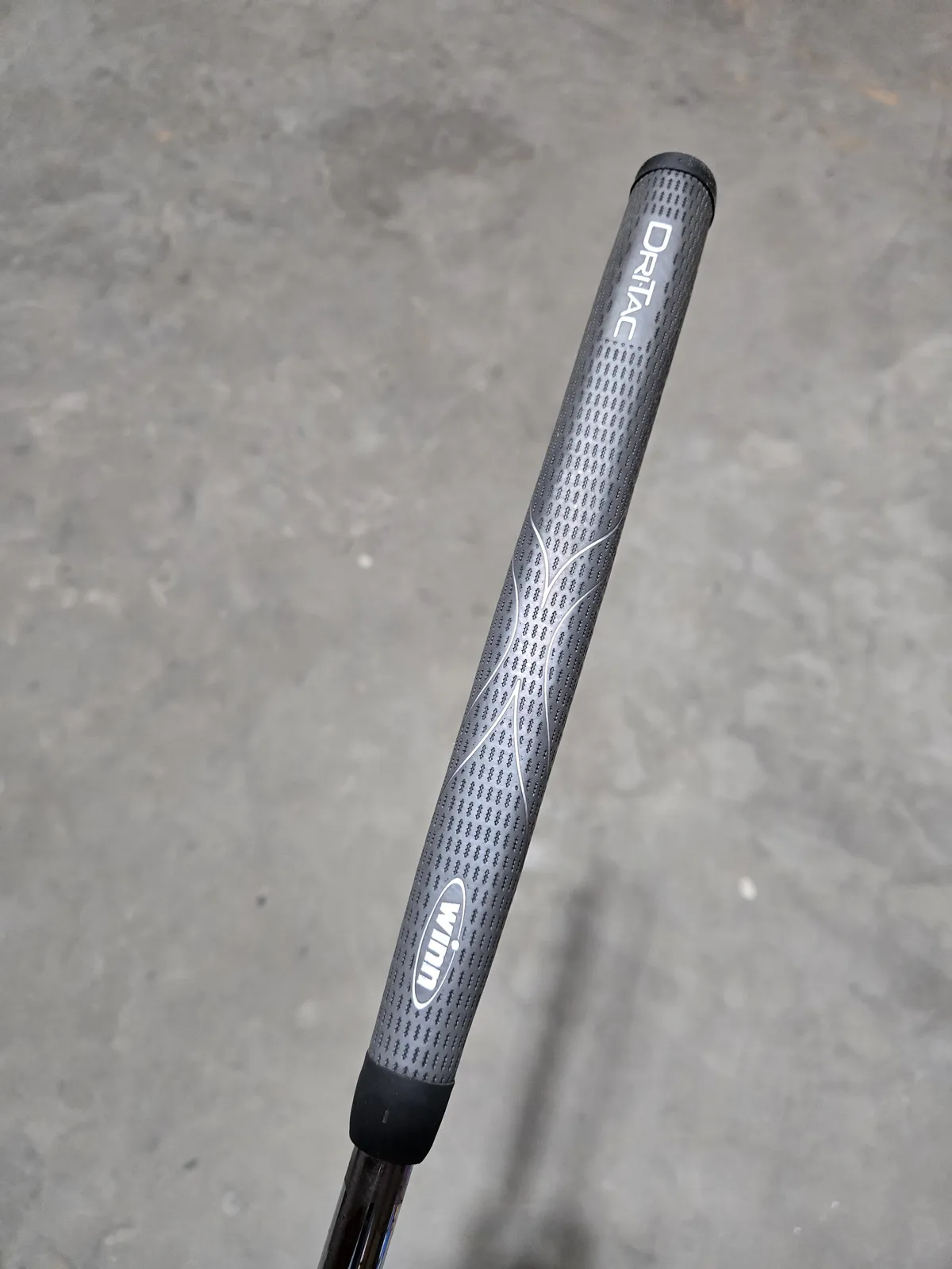 Winn Dri-Tac putter grip installed on my putter — same soft, tacky material as the club grips